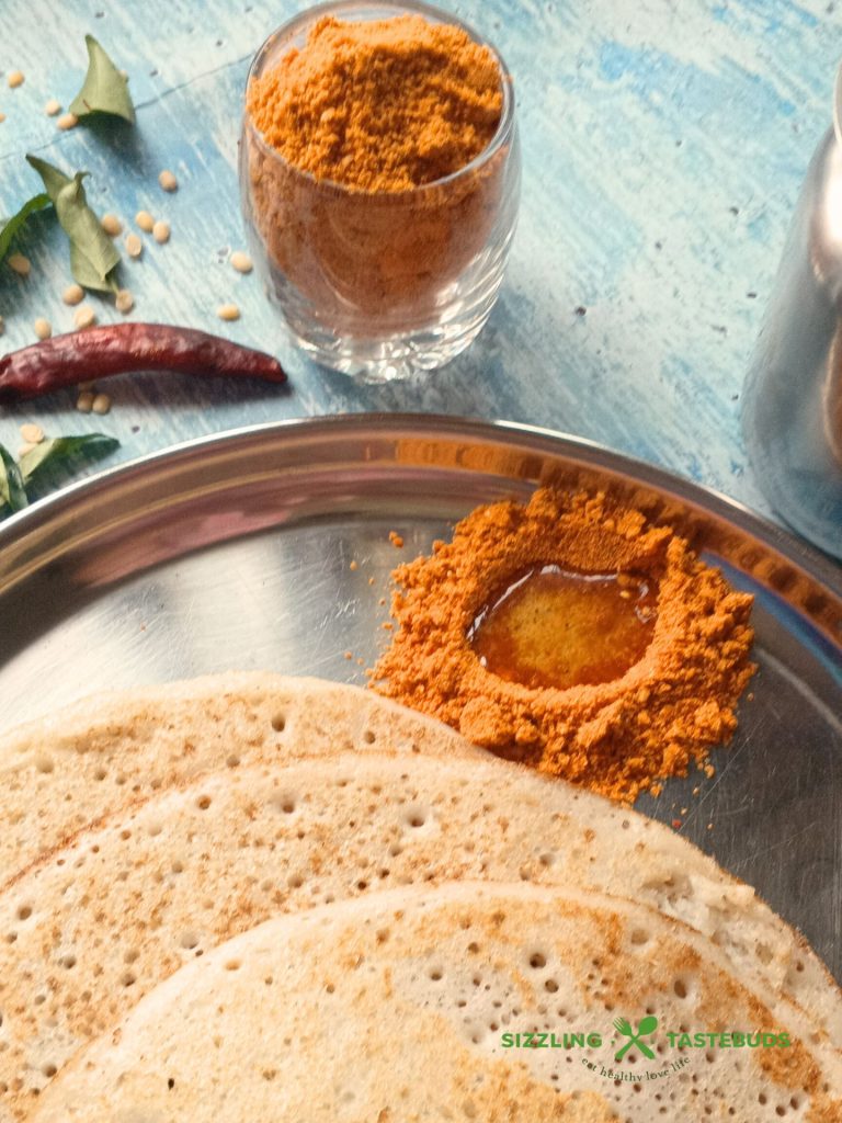 Molagapudi, or "gunpowder," is a bold South Indian spice blend of roasted lentils and chillies, typically served with oil or ghee with Idli and Dosa.