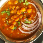Safed Vatanyachi Usal is a curry made with rehydrated white peas slow cooked in a tangy spicy base. Served with Pav (bread rolls) or Roti (Flatbread).