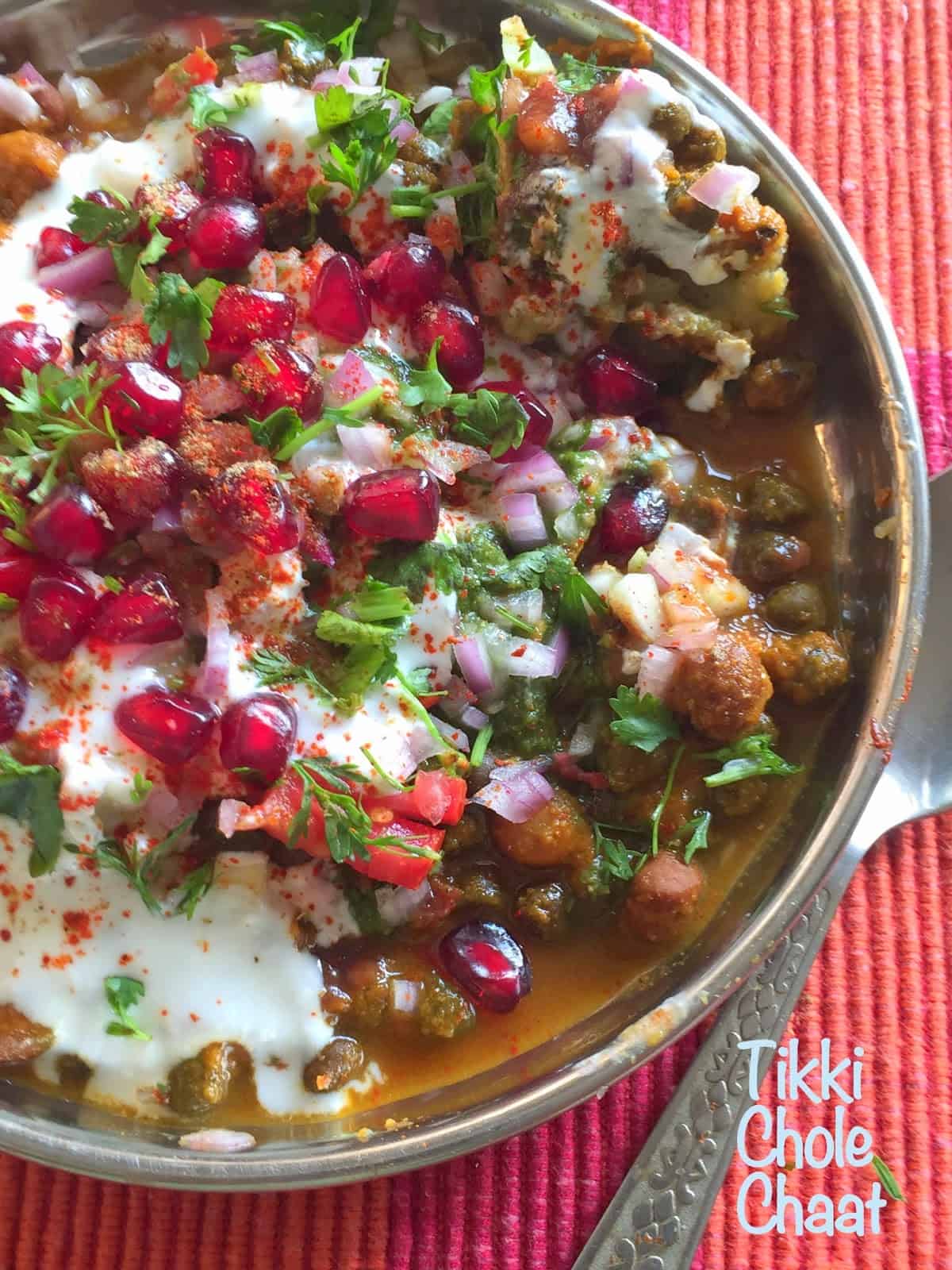 Tikki Chole Chaat is a delicious street food combining tikki (potato patties, shallow fried) with a spicy-tangy chickpea curry. Served topped with onions and chutney