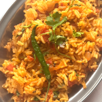 Tomato Rice is a gluten free, Vegan and Easy One Pot meal made with tomatoes, Cooked rice and everyday spices. Works for lunchbox or potluck too.