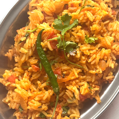 Tomato Rice is a gluten free, Vegan and Easy One Pot meal made with tomatoes, Cooked rice and everyday spices. Works for lunchbox or potluck too.