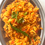 Tomato Rice is a gluten free, Vegan and Easy One Pot meal made with tomatoes, Cooked rice and everyday spices. Works for lunchbox or potluck too.