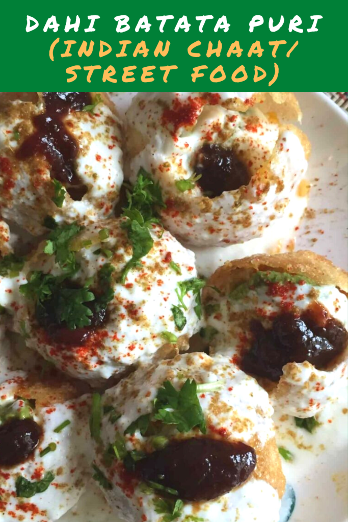 A delicious chaat / Indian street food made with boiled potato, beaten yogurt topped with spicy tangy chutneys