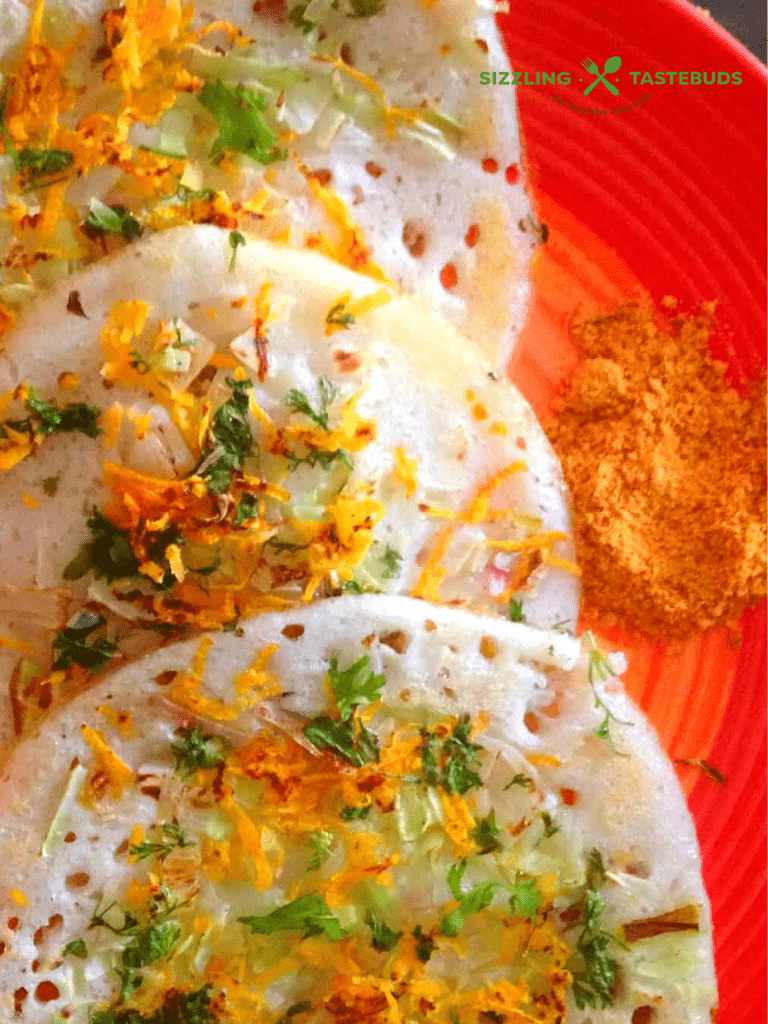 Thinai Uttapam or Foxtail Millet Uttapam is a thick dosa (savoury pancake) made with millets topped with vegetables. 100% Gluten Free and Vegan. Served as breakfast or snack.