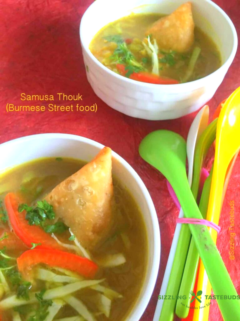 Samosa thouk is a Burmese street food delight blending chopped samosas with zesty vegetables and tangy dressing.
