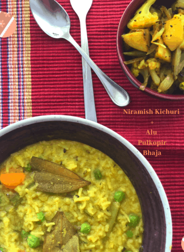 Niramish Kichuri is a Bengali staple with rice and lentils cooked in a satvik (no onion no garlic) base with vegetables. Served for lunch or brunch with a veggie side.