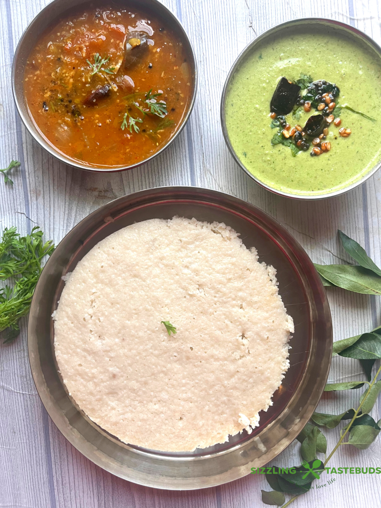 Thatte Idli is a famous gluten free,vegan breakfast dish from Bidadi (outskirts of Bangalore) where batter is steamed in leaf lined flat plates which gives its characteristic shape and softness