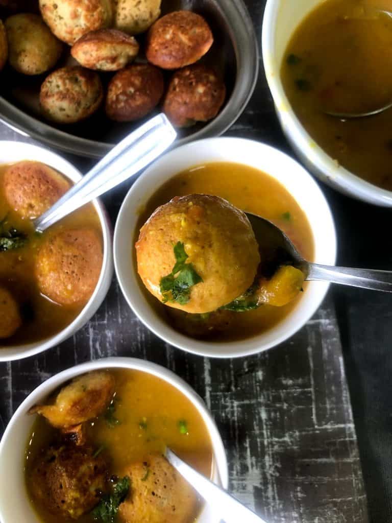 Darshini Style Bonda Soup is a protein rich Snack / Appetiser which is NOT deep fried. The lentil dumplings are served in an aromatic soup like broth 