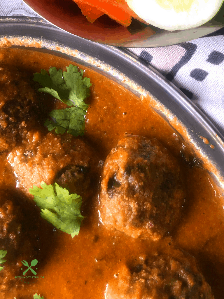 Lauki Methi Kofta Curry is a Low-fat Indian Curry (Gluten Free+vegan) made with bottlegourd and fenugreek leaves dumplings that are simmered in a spicy tomato base. Served with flatbreads and rice.