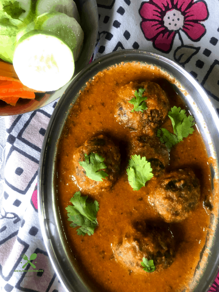 Lauki Methi Kofta Curry is a Low-fat Indian Curry (Gluten Free+vegan) made with bottlegourd and fenugreek leaves dumplings that are simmered in a spicy tomato base. Served with flatbreads and rice.