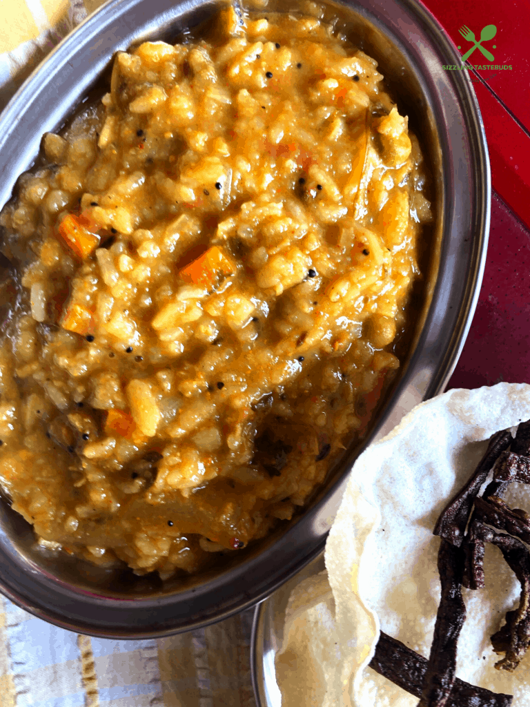 A Karnataka special One Pot Meal made with Lentils, veggies and flattened rice spiced with an aromatic powder.