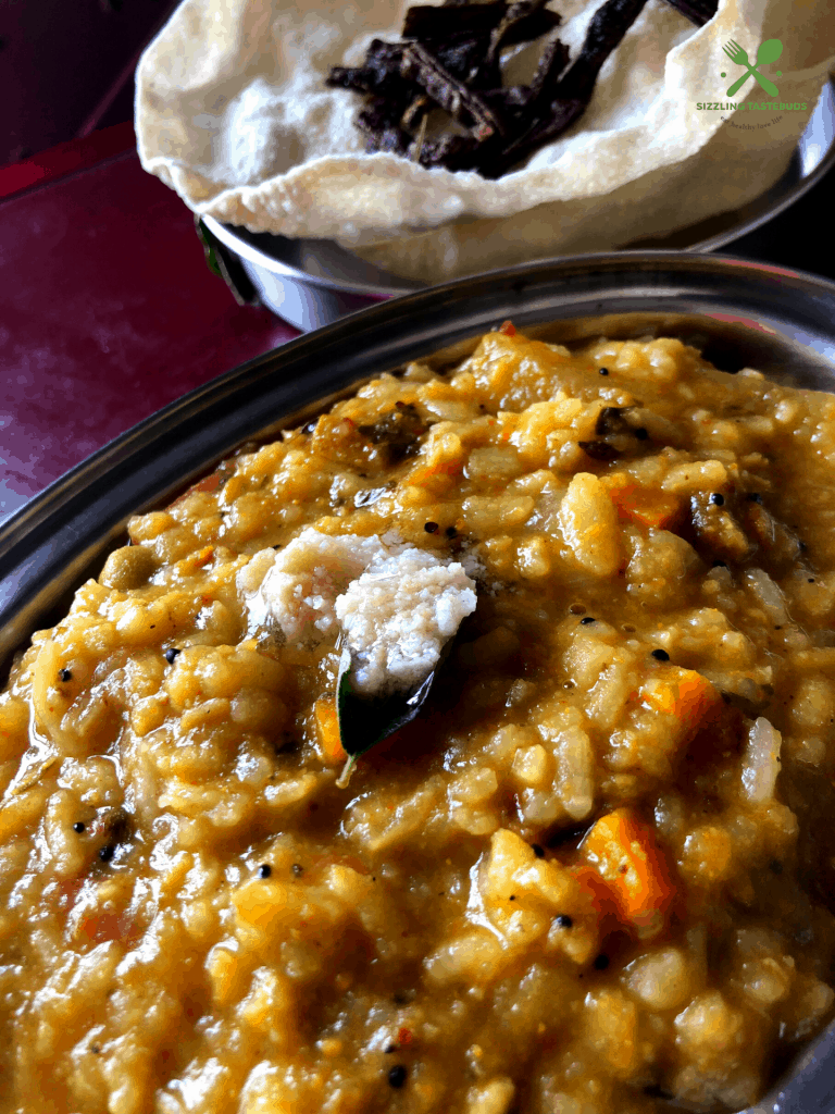 A Karnataka special One Pot Meal made with Lentils, veggies and flattened rice spiced with an aromatic powder.