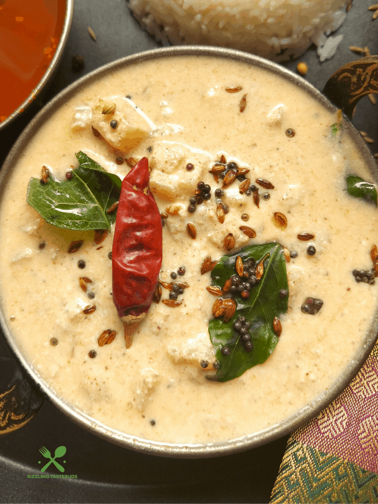 Vazhai Thandu Mor Kootu is a spiced curry made with yoghurt and tender banana stem. This is usually served with Sambhar and steamed rice.