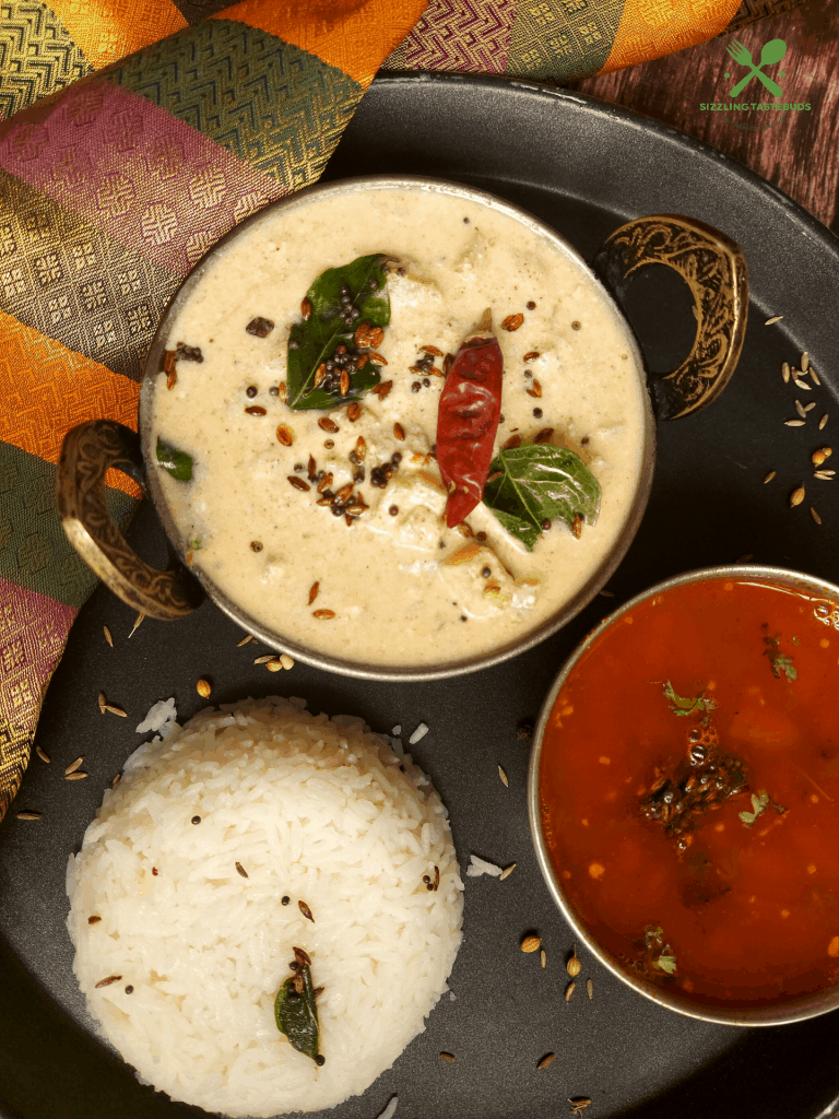 Vazhai Thandu Mor Kootu is a spiced curry made with yoghurt and tender banana stem. This is usually served with Sambhar and steamed rice.