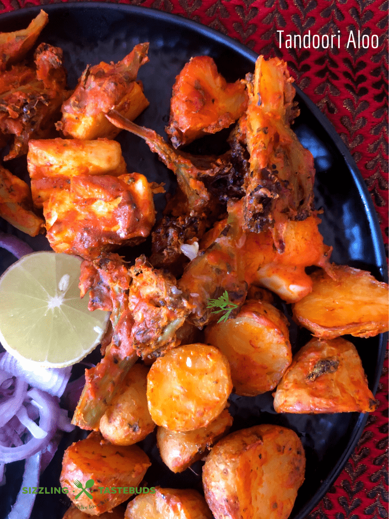 Tandoori Aloo is a gluten free snack made with marinated baby potatoes baked in a Tandoor (or an oven) and served with a spicy-tangy coriander mint sauce and a salad on the side.