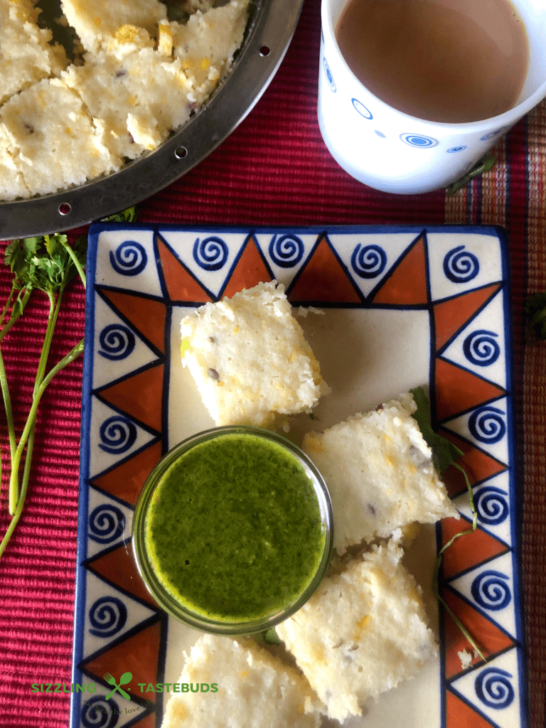 Brown Rice Corn Dhokla is a Gluten free steamed snack, made from Brown Rice and Corn. Served with Mint - Coriander Chutney