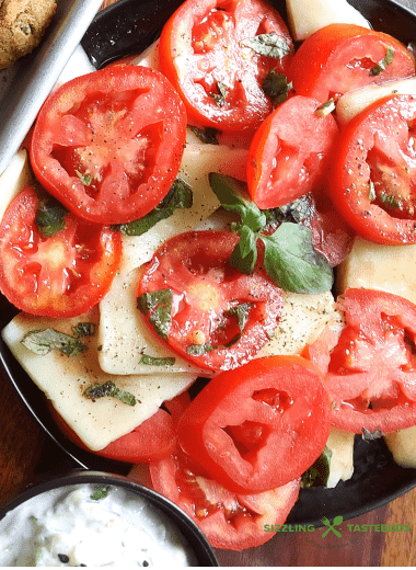 A Summer delight, Caprese salad is a quick, delicious Italian salad or a side which uses Juicy Tomatoes and Mozzarella with other basic ingredients