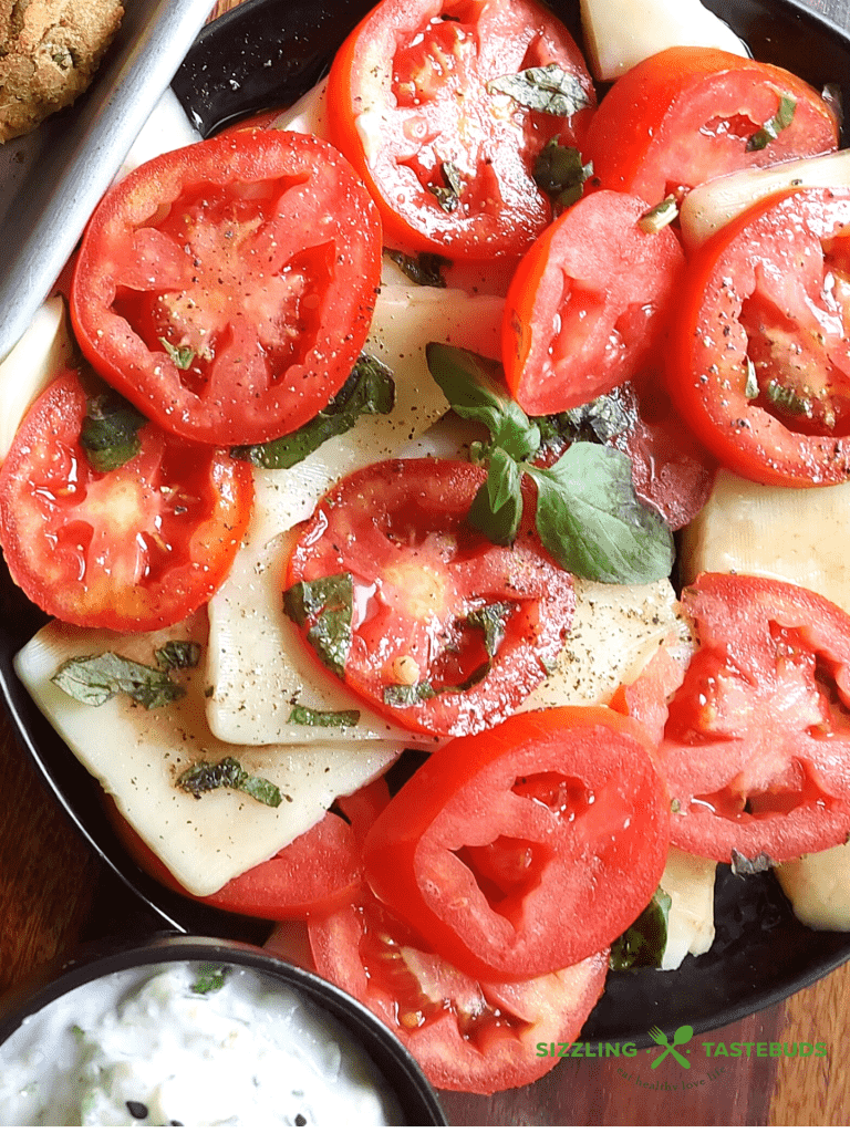 A Summer delight, Caprese salad is a quick, delicious Italian salad or a side which uses Juicy Tomatoes and Mozzarella with other basic ingredients