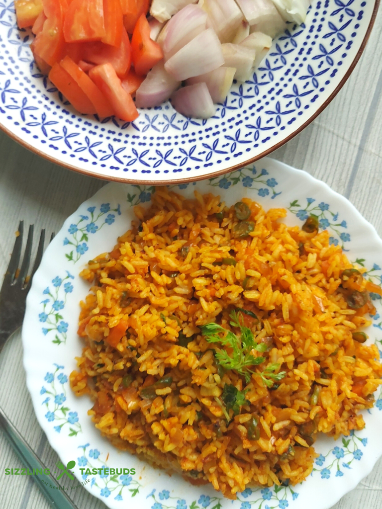 Jollof Rice is a quick One Pot meal that is bursting with spices, peppers and is usually served as main Course with meat / veggie sides