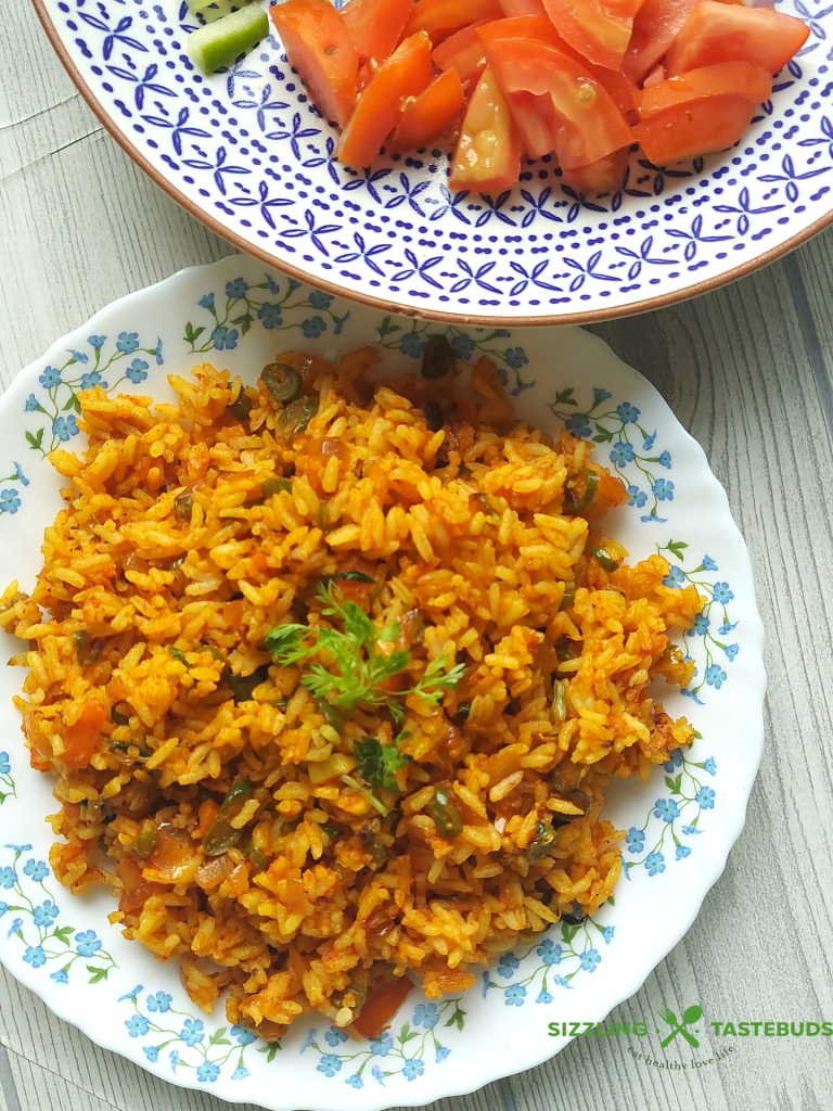 Jollof Rice is a quick One Pot meal that is bursting with spices, peppers and is usually served as main Course with meat / veggie sides