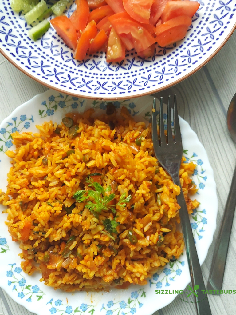 Jollof Rice is a quick One Pot meal that is bursting with spices, peppers and is usually served as main Course with meat / veggie sides