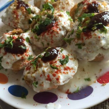 A delicious chaat / Indian street food made with boiled potato, beaten yogurt topped with spicy tangy chutneys