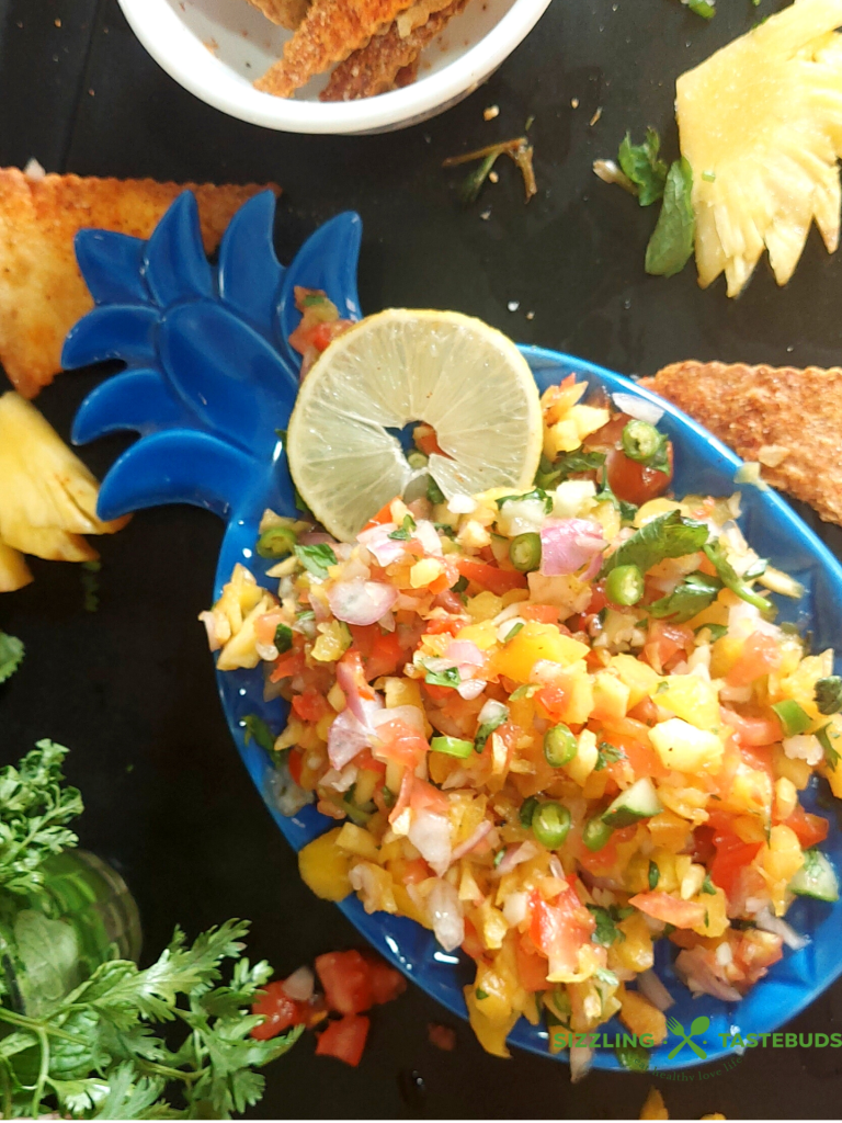 Roasted Pineapple Salsa is a delicious salsa made with roasted pineapples, seasonal fruit and a basic dressing. Perfect as an appetiser / side for parties or potluck