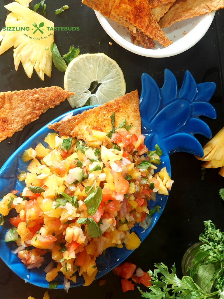 Roasted Pineapple Salsa is a delicious salsa made with roasted pineapples, seasonal fruit and a basic dressing. Perfect as an appetiser / side for parties or potluck