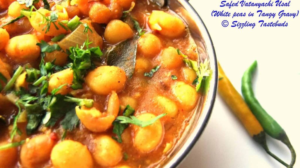 Safed Vatanyachi Usal is a curry made with rehydrated white peas slow cooked in a tangy spicy base. Served with Pav (bread rolls) or Roti (Flatbread).