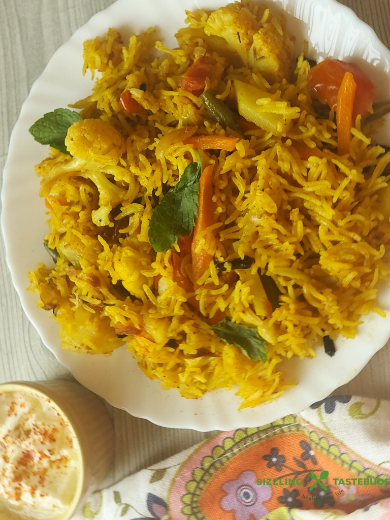 Let’s make this delicious and quick Pressure Cooker Veg Biryani that goes so well with raita / salad / papad for brunch or office / school lunchboxes too. Or a #potluck too ! 