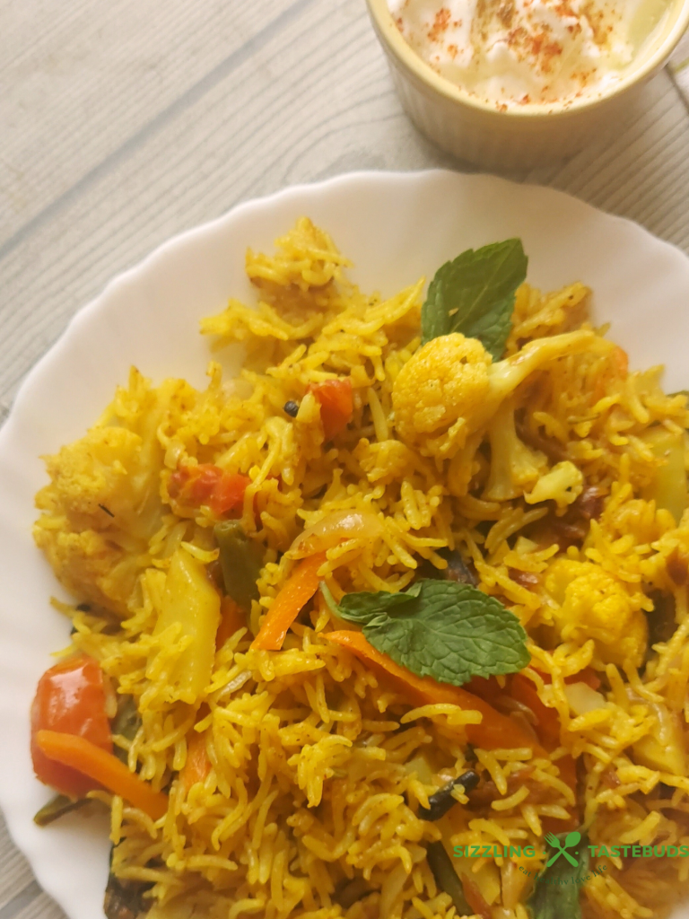 Let’s make this delicious and quick Pressure Cooker Veg Biryani that goes so well with raita / salad / papad for brunch or office / school lunchboxes too. Or a #potluck too ! 