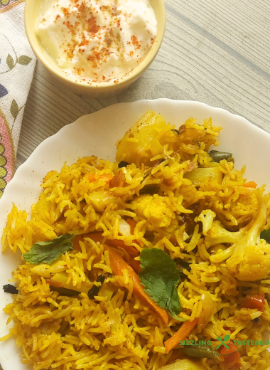 Let’s make this delicious and quick Pressure Cooker Veg Biryani that goes so well with raita / salad / papad for brunch or office / school lunchboxes too. Or a #potluck too ! 