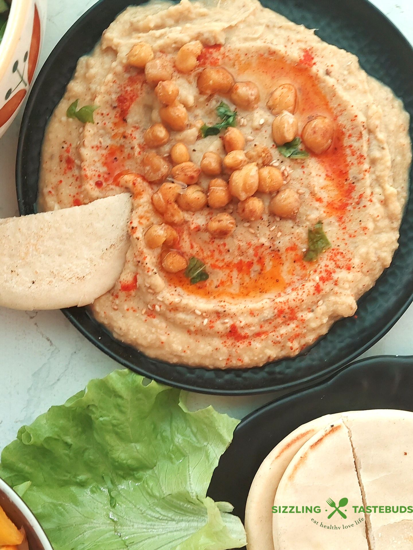 Hummus, a creamy Middle Eastern dip made from blended chickpeas, tahini, olive oil, and spices, offers a delicious and nutritious addition to your table – perfect for dipping, spreading, or enhancing your favorite dishes.