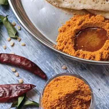 Molagapudi, or "gunpowder," is a bold South Indian spice blend of roasted lentils and chillies, typically served with oil or ghee with Idli and Dosa.